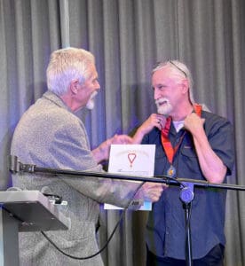 Earl Showerman presenting the Tom Regnier Veritas Award to Roger Stritmatter